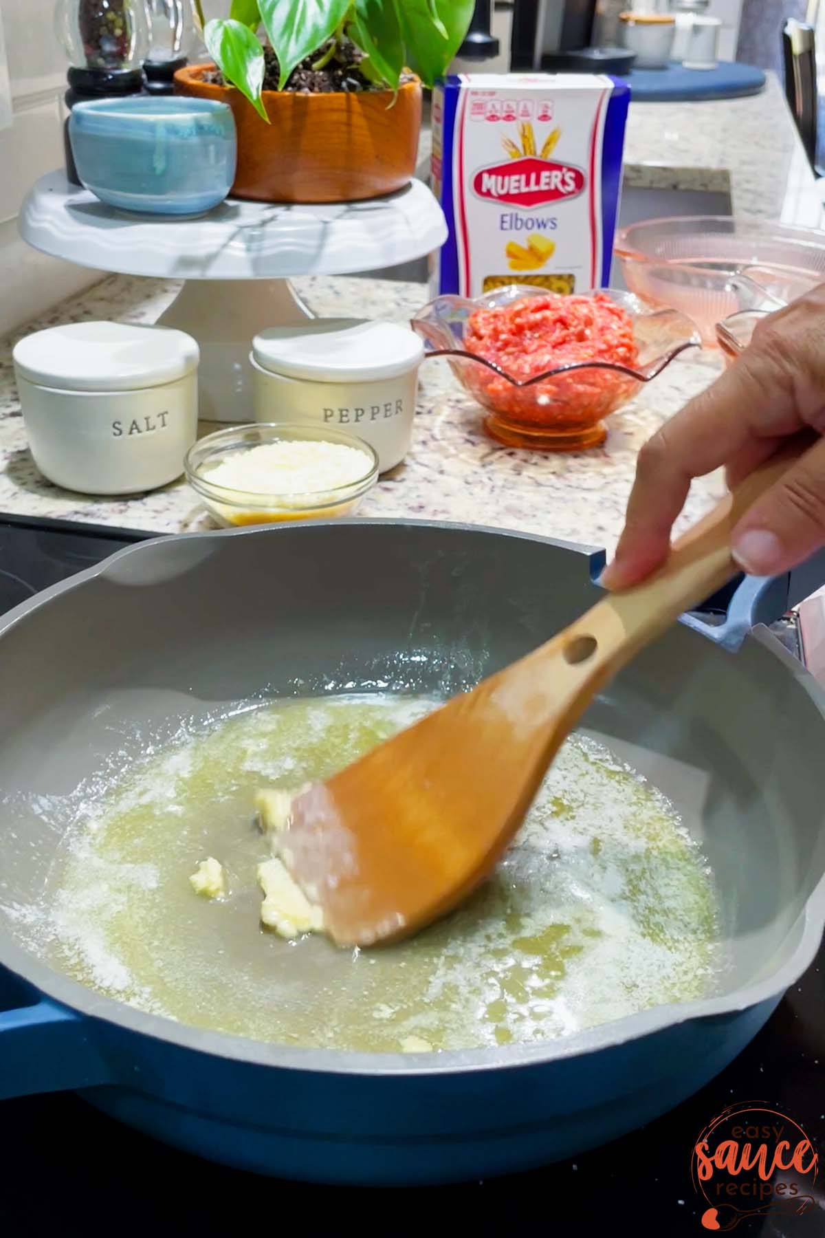adding garlic to butter in pan