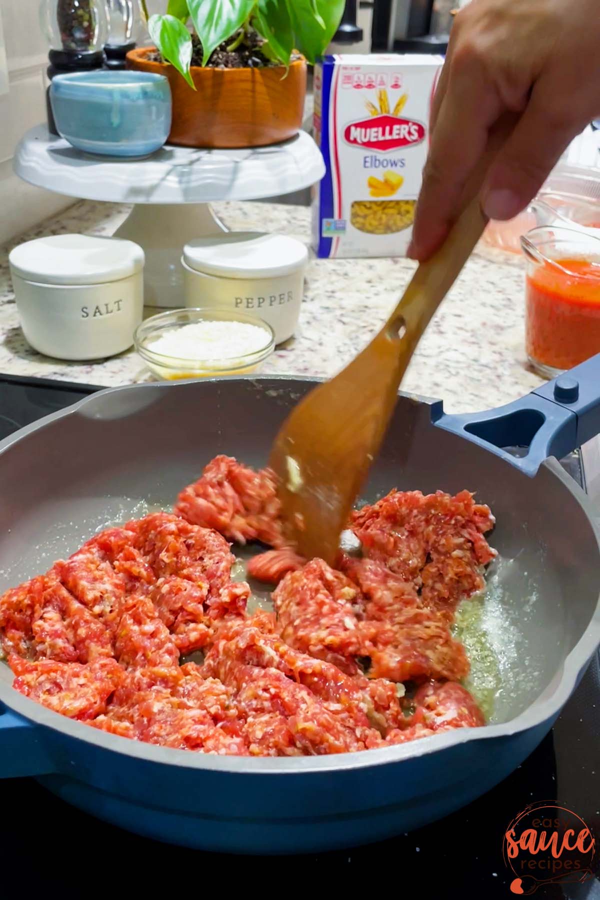 cooking sausage in a pan for pink pasta sauce