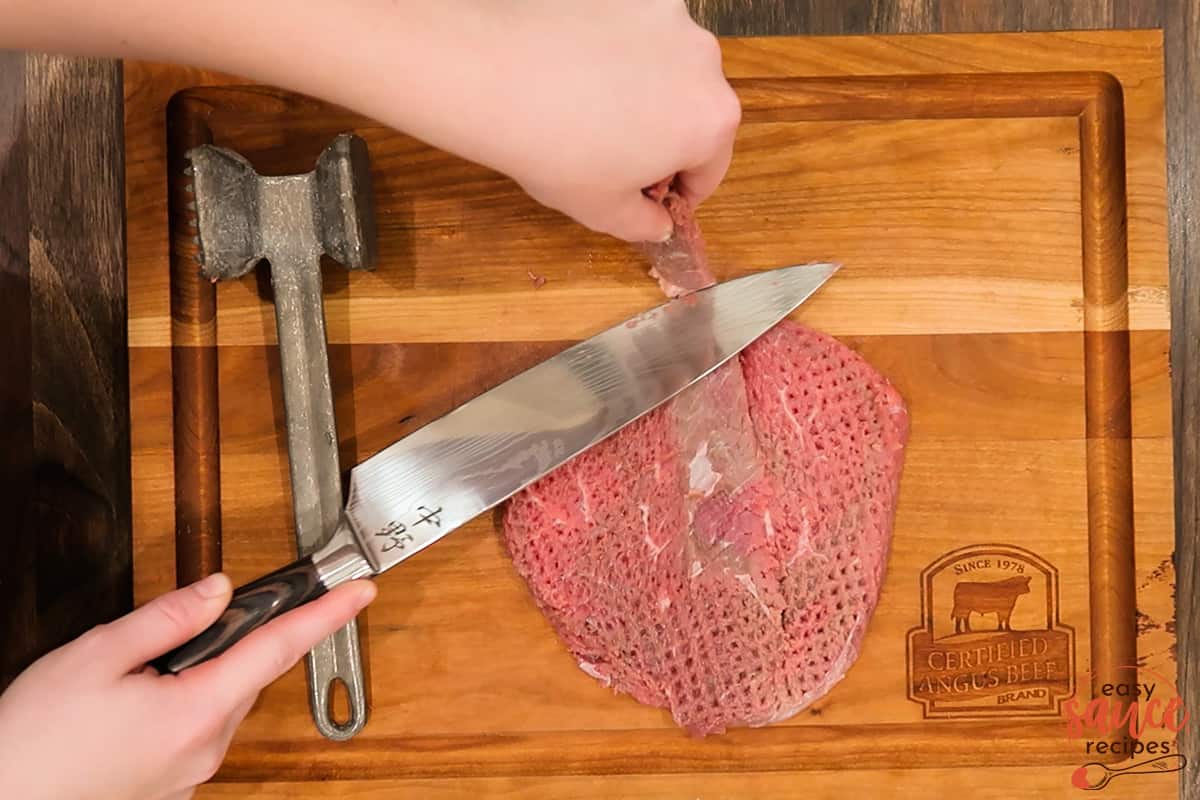 slicing silver skin away from a steak