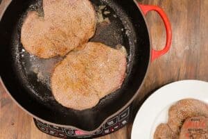 steaks searing in pan
