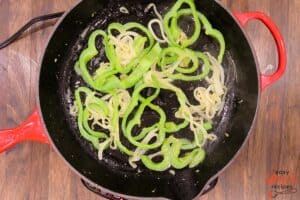 cooking peppers and onions for pizzaiola sauce in a pan