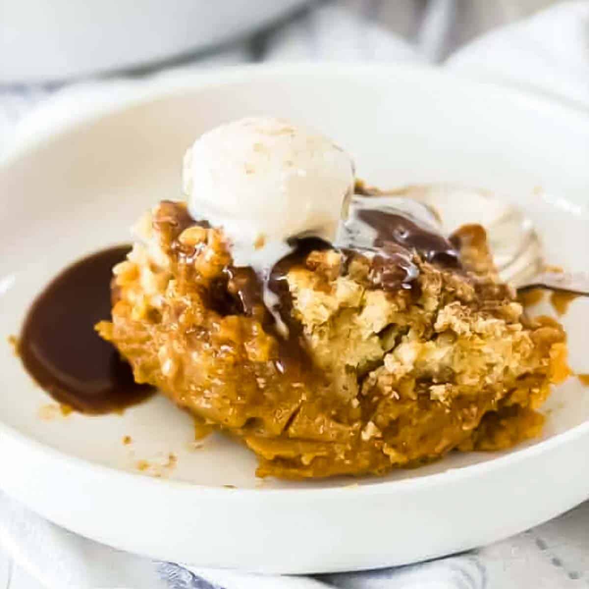 ice cream melting over pumpkin cobbler with toffee sauce