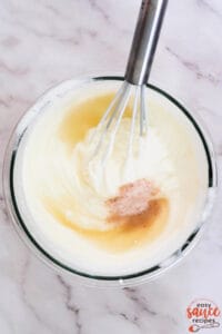 a bowl of crema sauce being whisked together