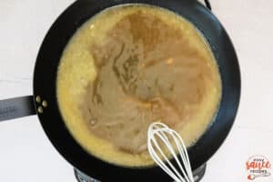 brown gravy with chicken broth in a skillet
