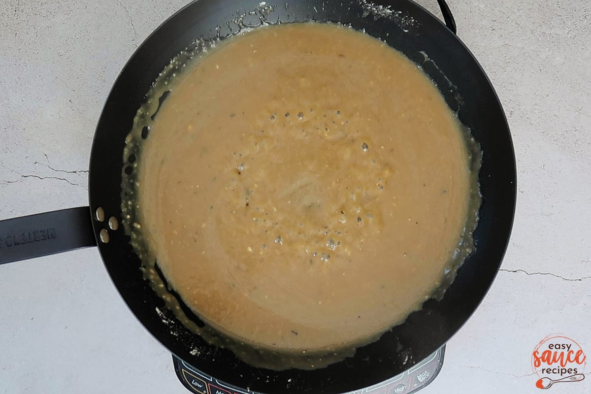 brown gravy in a skillet bubbling
