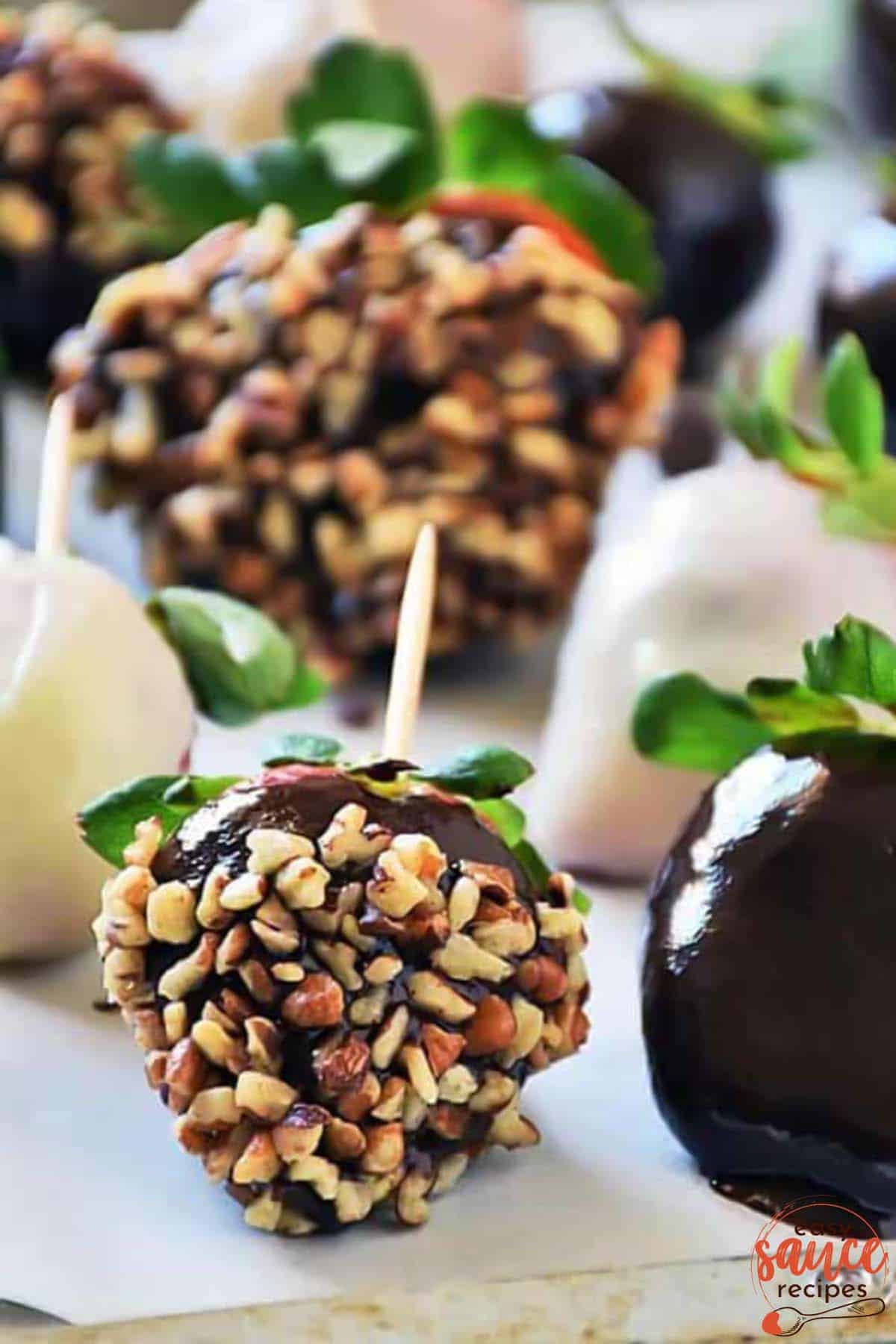 chocolate ganache covered strawberries with nuts