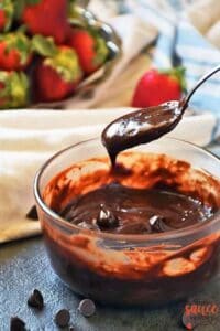 chocolate ganache on a spoon over a bowl