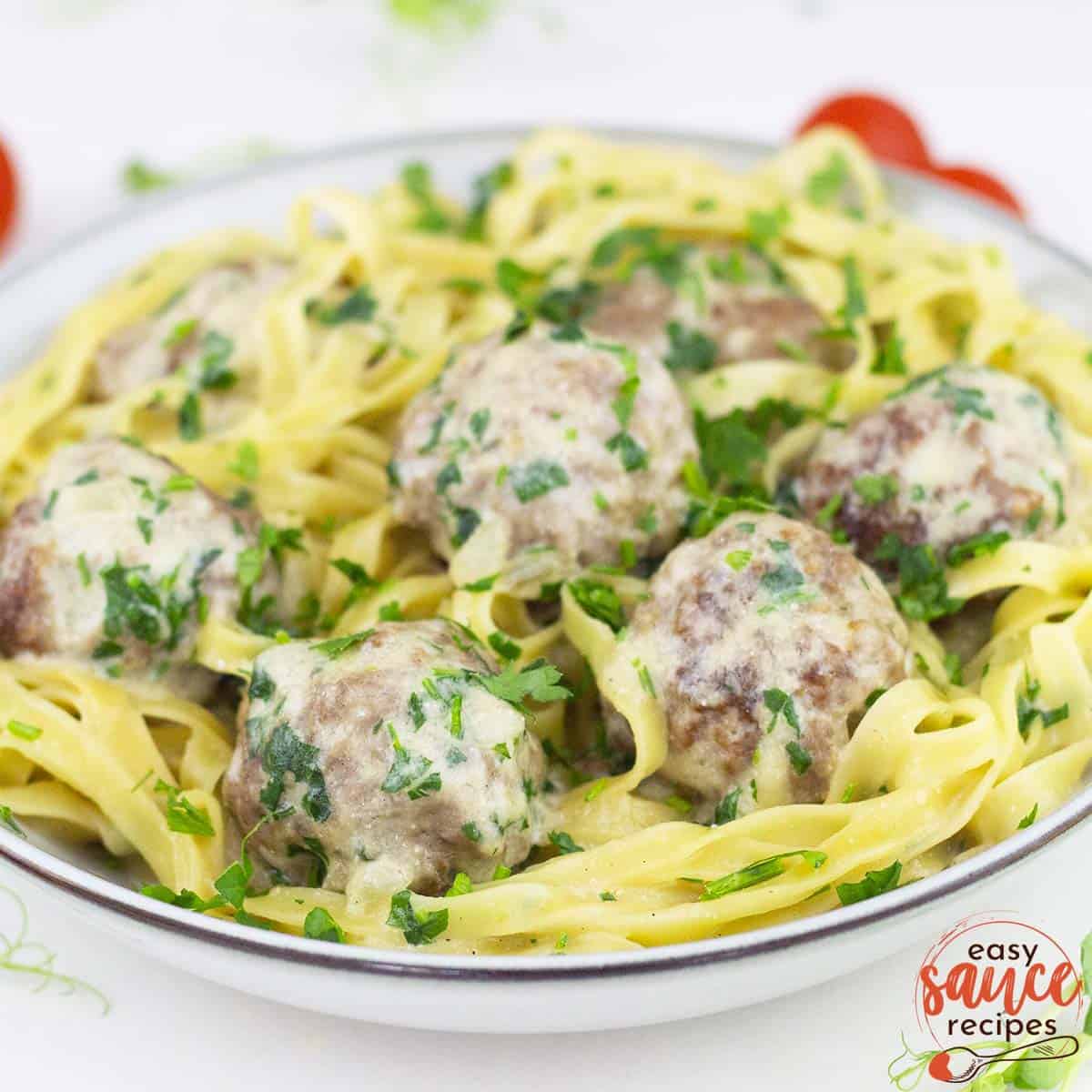 a bowl of meatballs and noodles with swedish meatballs sauce
