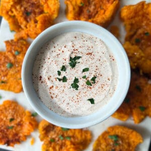 a dish of sweet potato dipping sauce on a plate with sweet potato chips