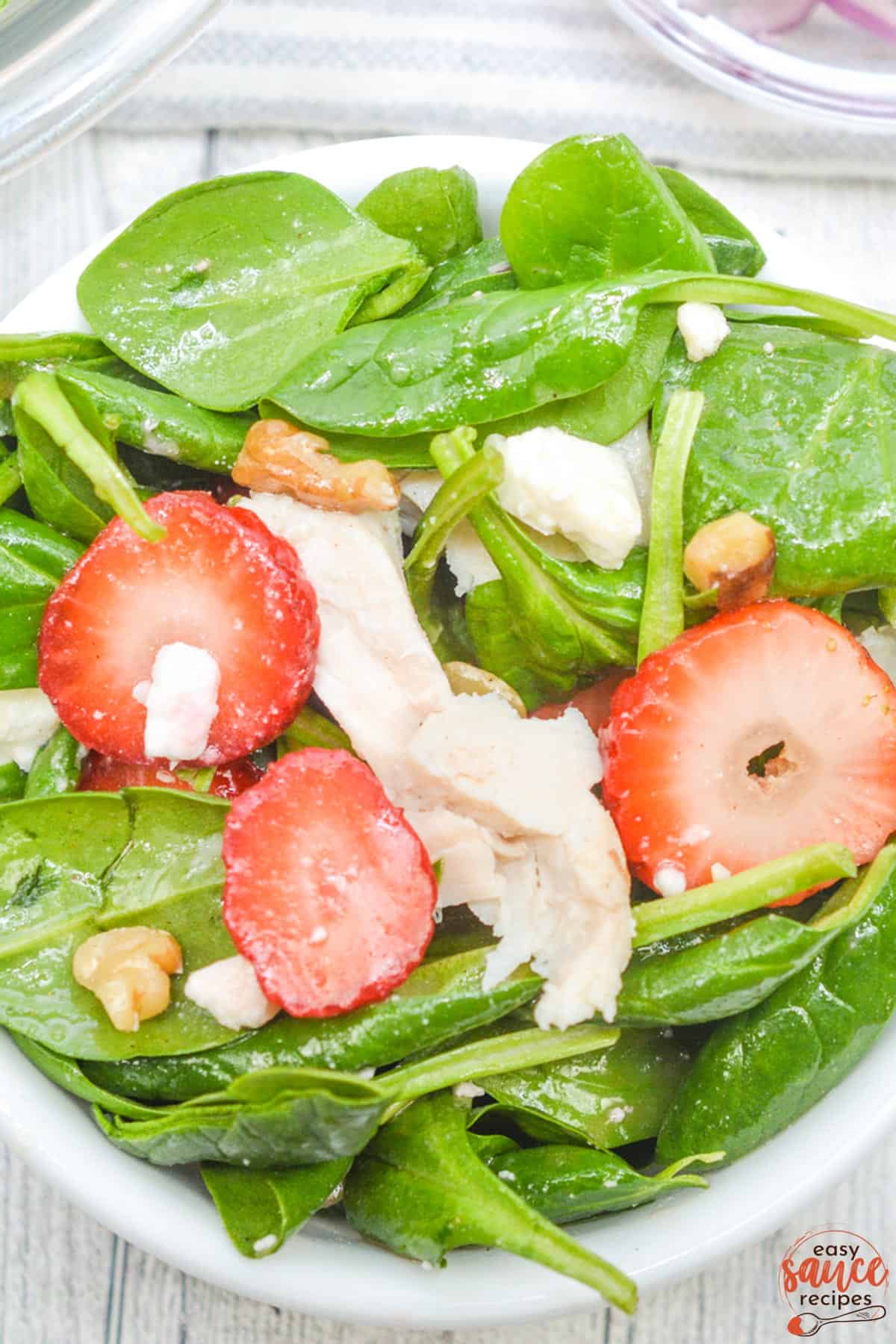 champagne vinaigrette overtop a salad with chicken
