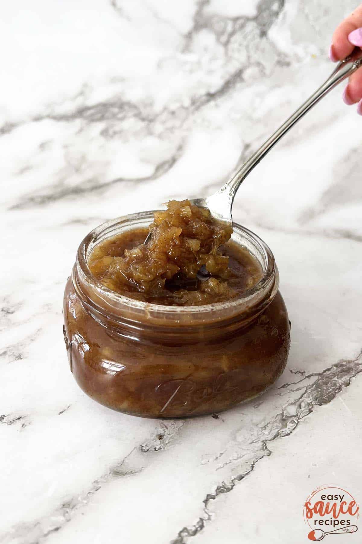 pineapple sauce for ham in a jar with a spoon