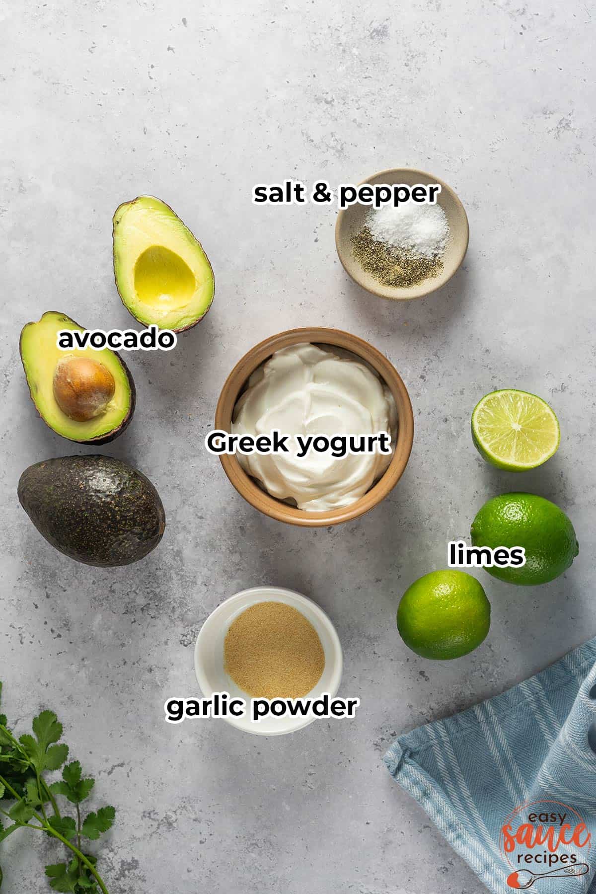 ingredients for avocado crema on a white surface