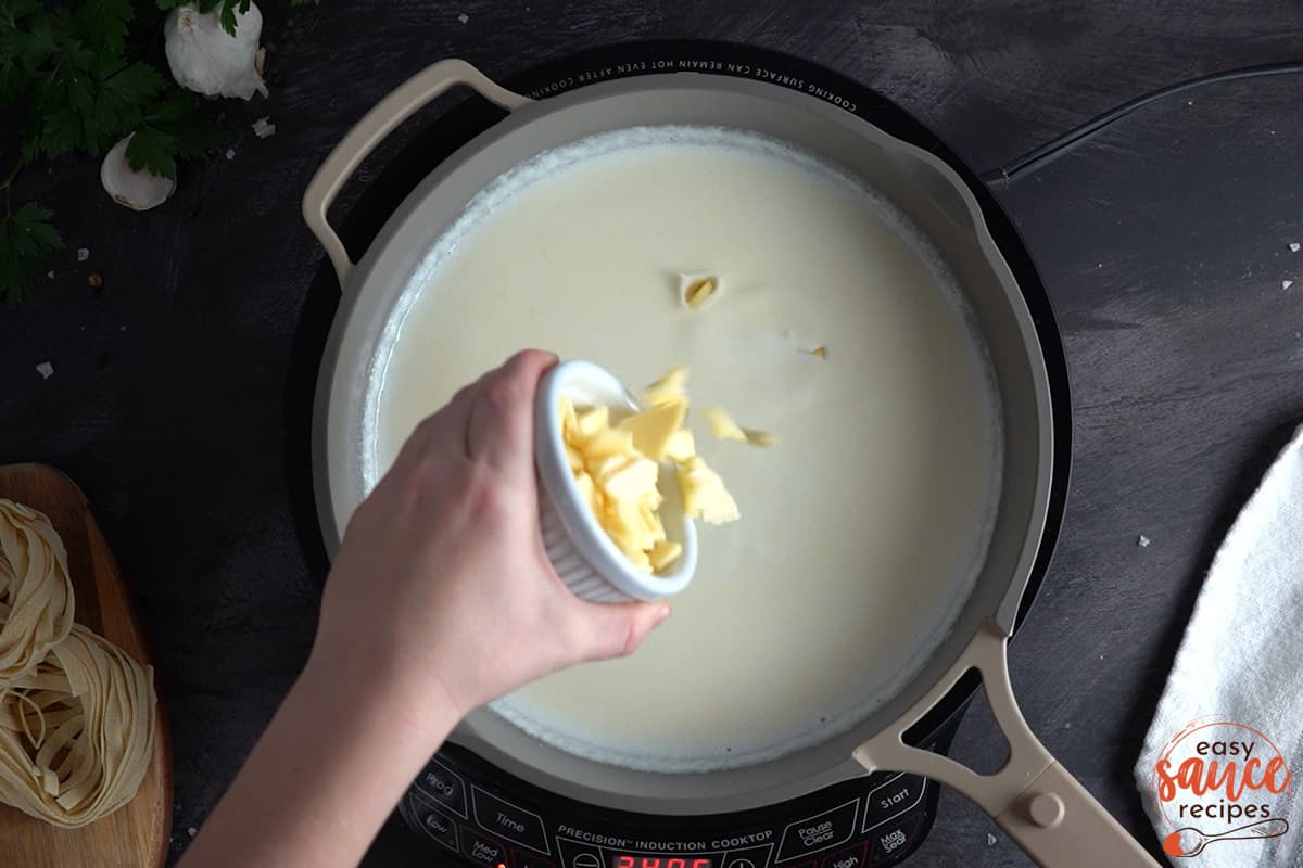 adding sliced American cheese in a skillet