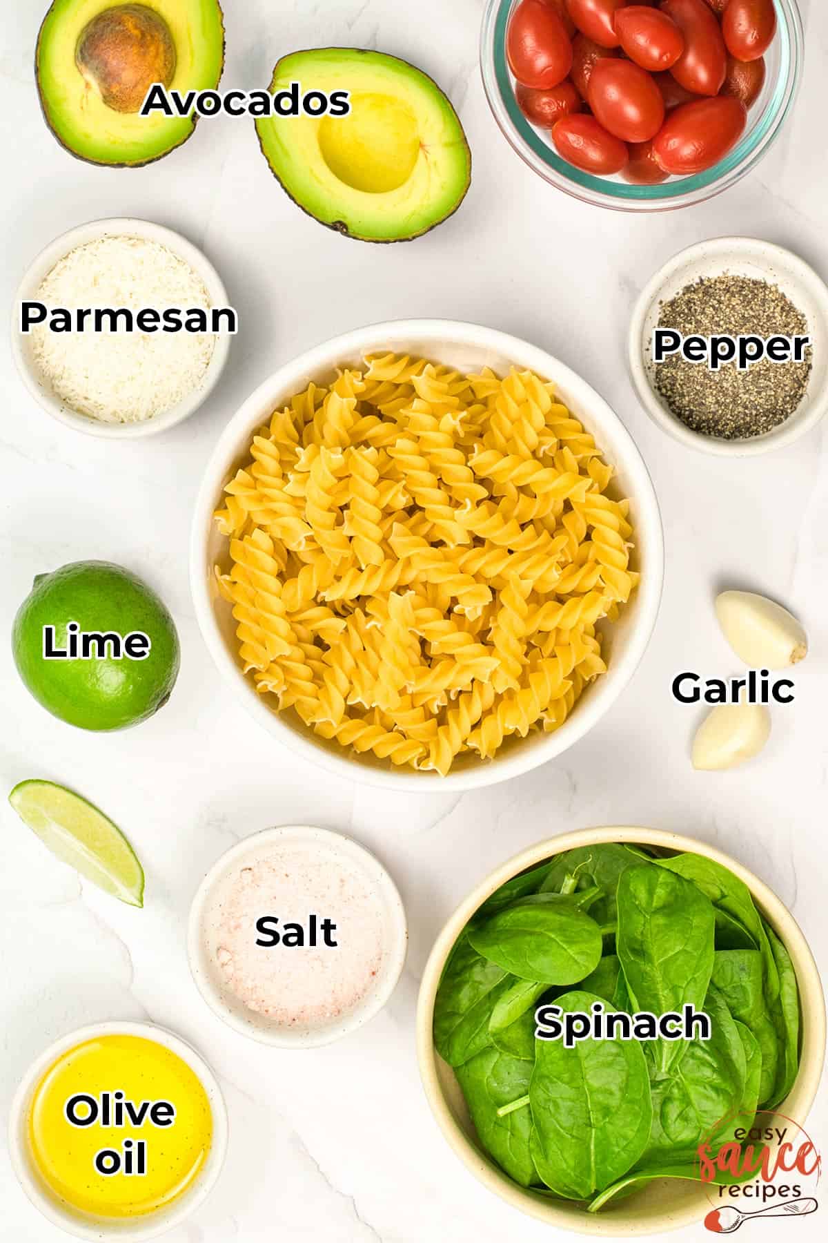 all the ingredients for avocado pasta sauce in separate bowls with labels
