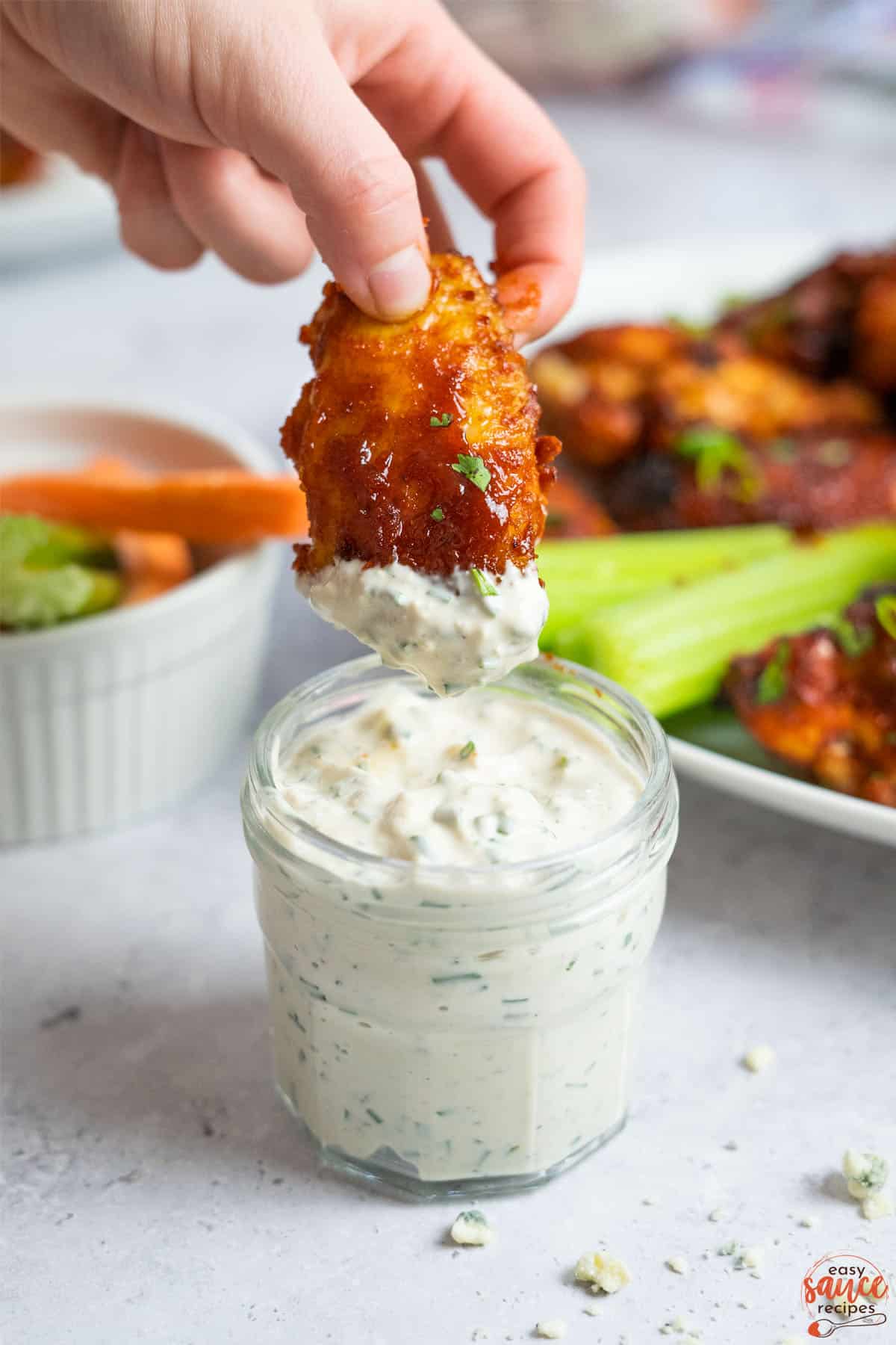 blue cheese in a clear dish with chicken wings