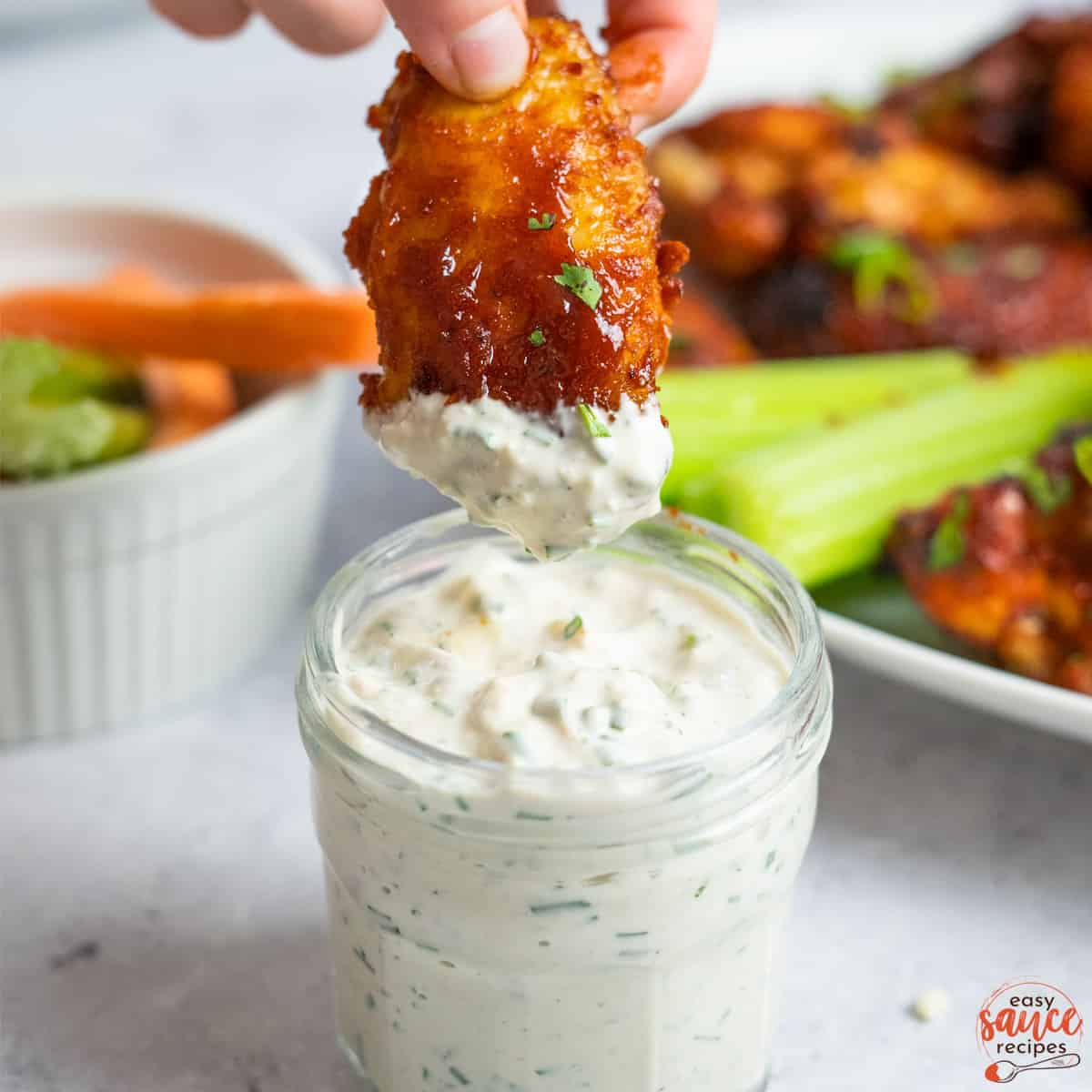 blue cheese with a wing dipping inside