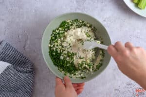 mixing blue cheese dressing in a bowl