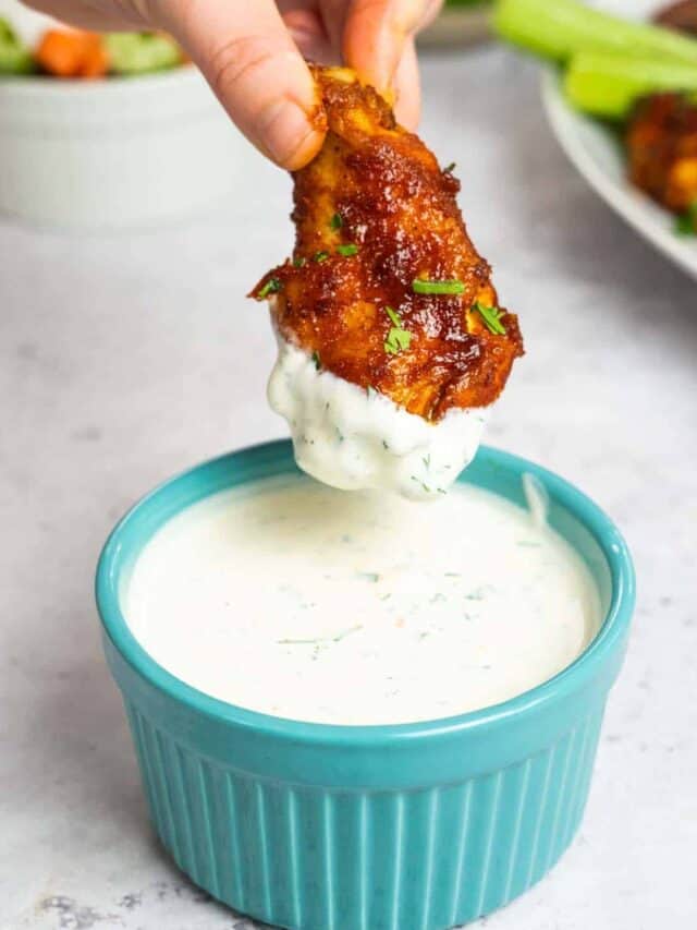 ranch in a blue dish with a chicken wing