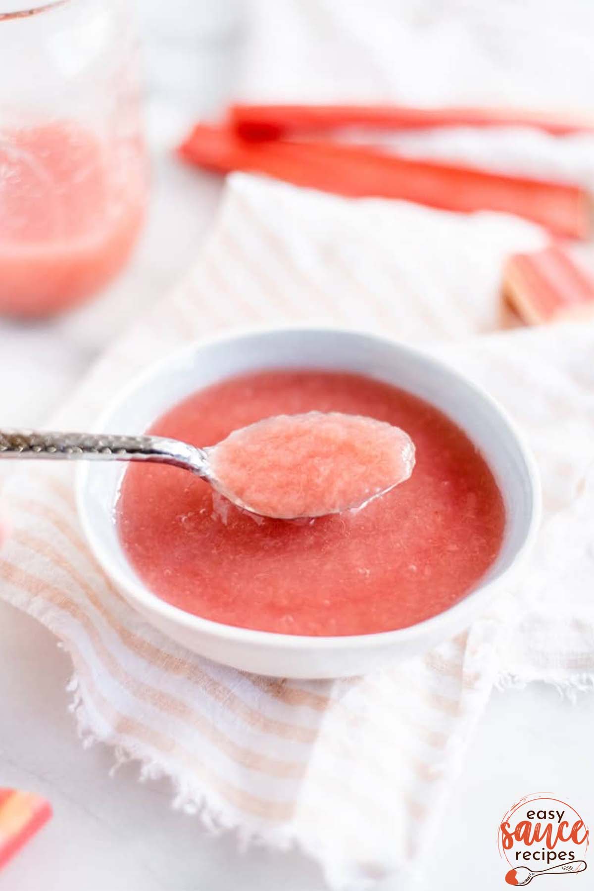 a spoonful of rhubarb sauce in a white bowl
