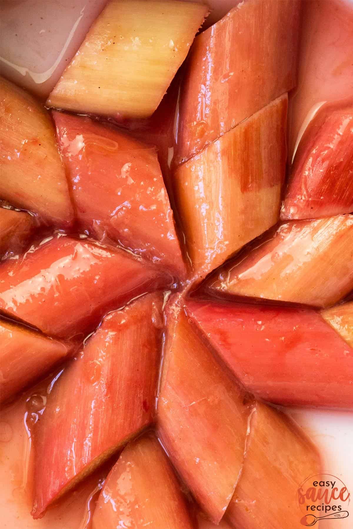 a closeup of stewed rhubarb arranged in a star shape in a pan