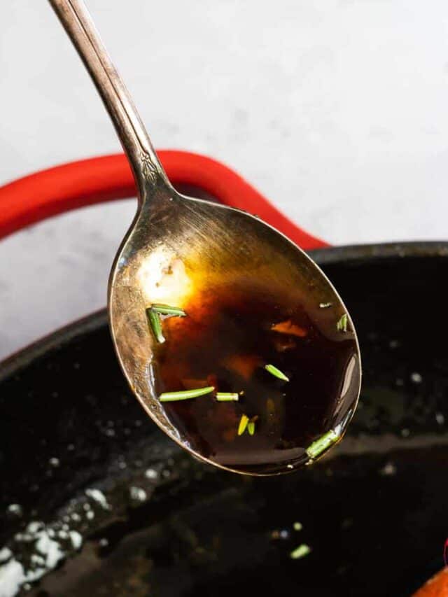a spoon full of honey garlic sauce with rosemary