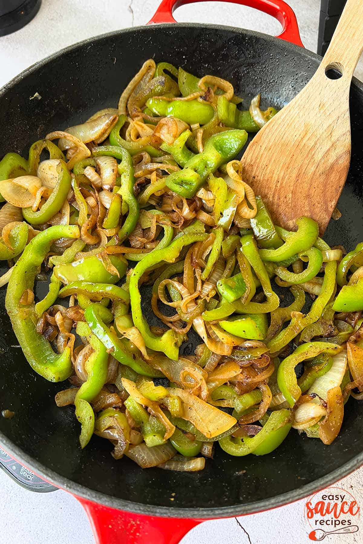 a pan of sauteed onions and peppers