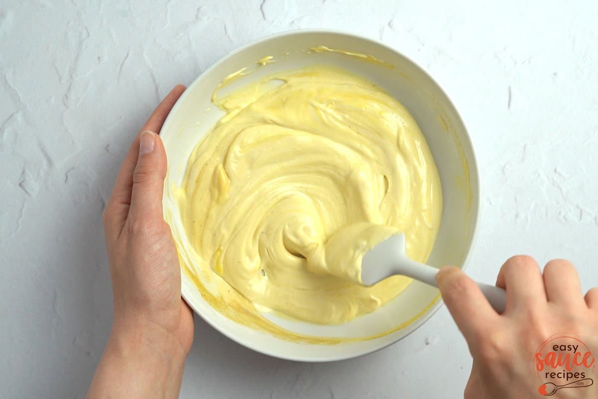 mixing mayo mustard sauce in a bowl