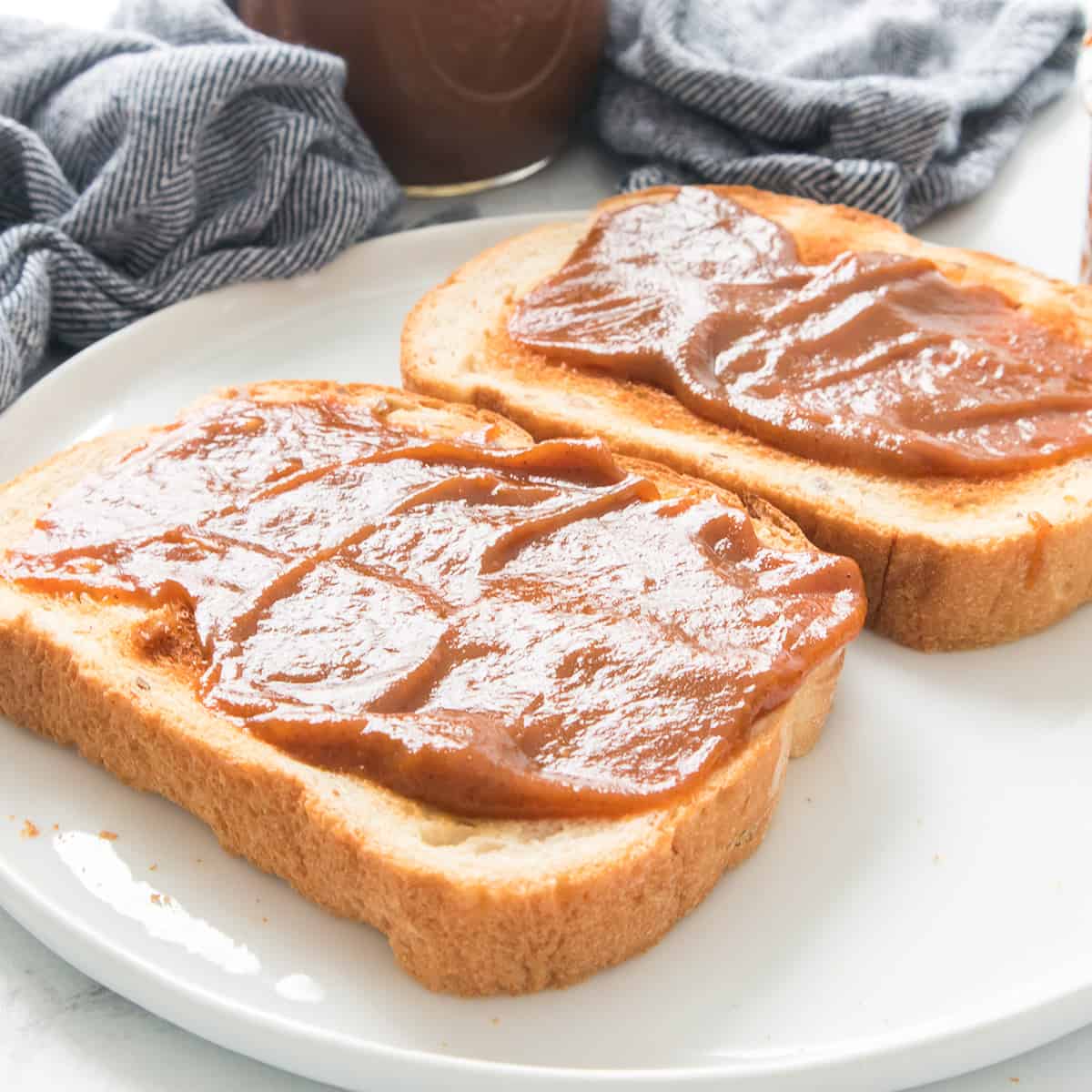 two slices of bread with pumpkin butter spread on top