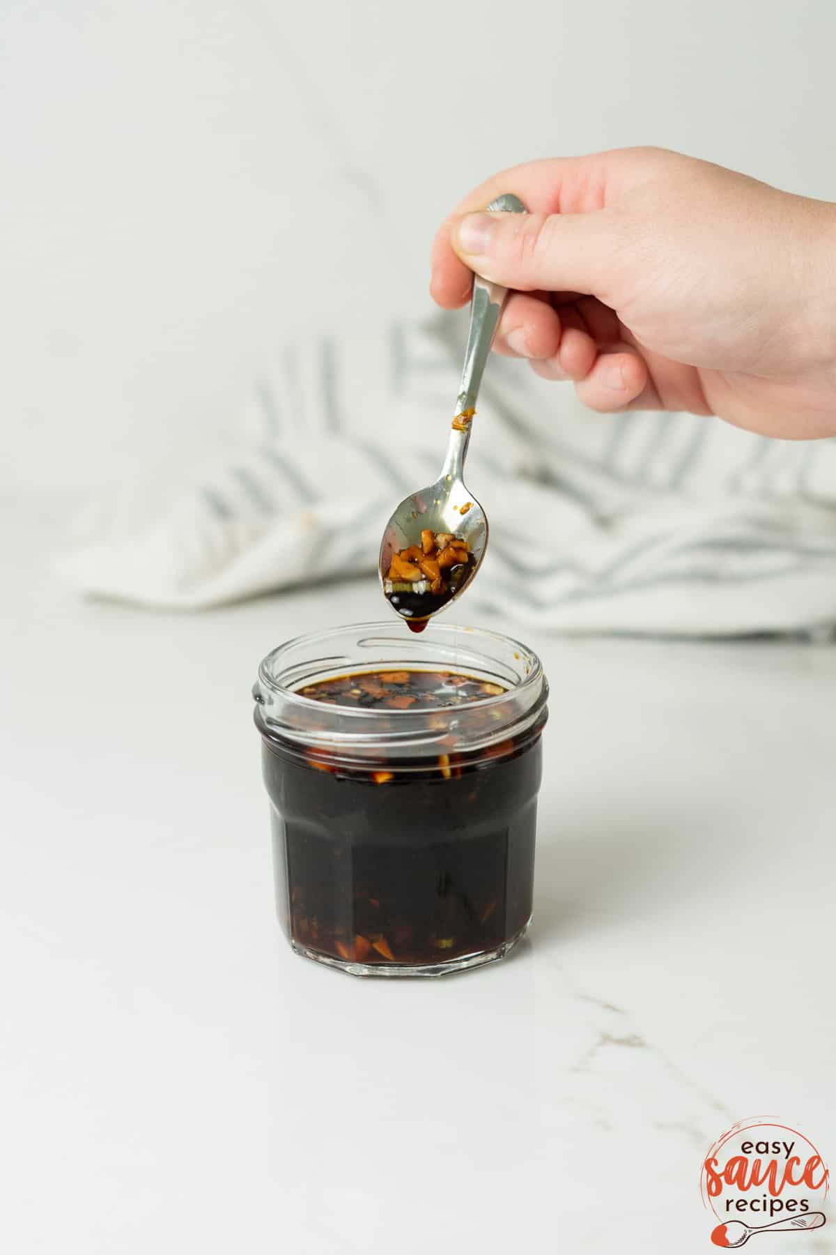 teriyaki sauce in a clear dish with a spoonful overtop