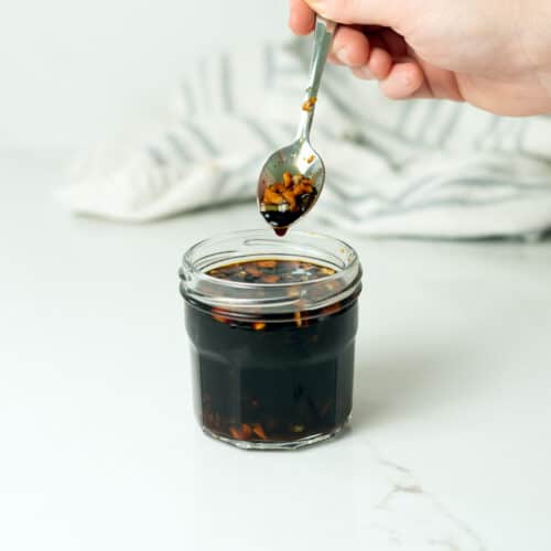 teriyaki sauce in a clear dish with a spoonful of sauce over top